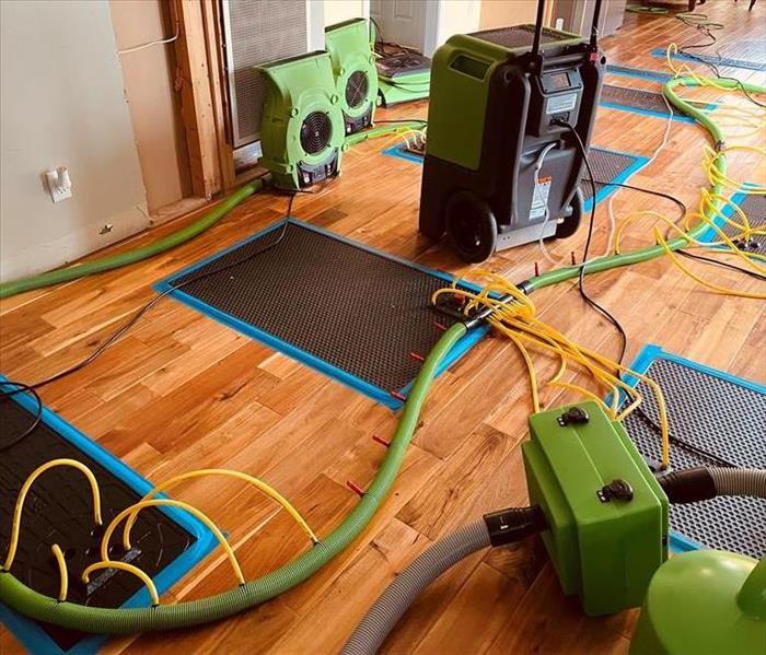 green equipment on tan wood floors